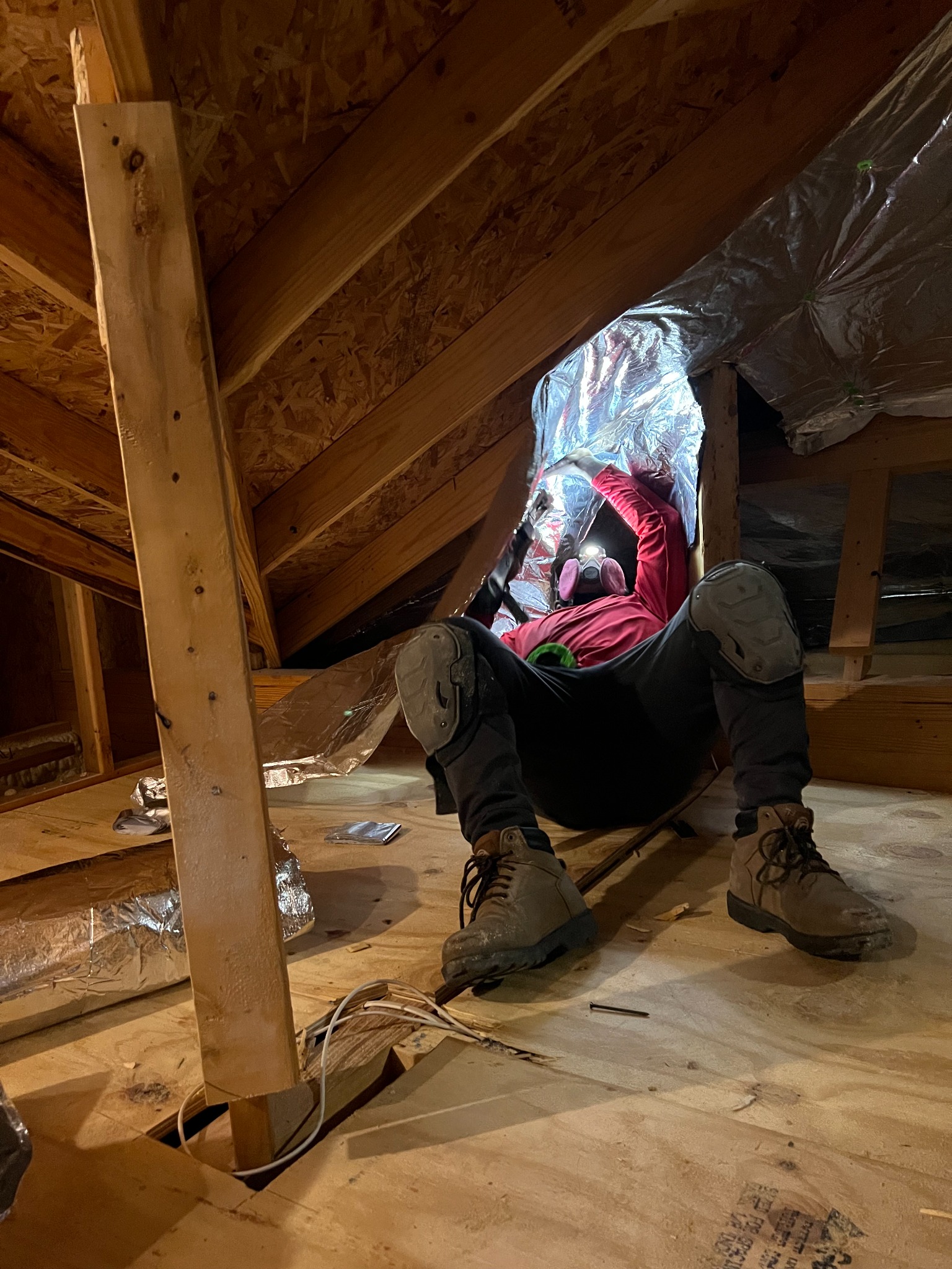 Technician installing radiant barrier in an attic