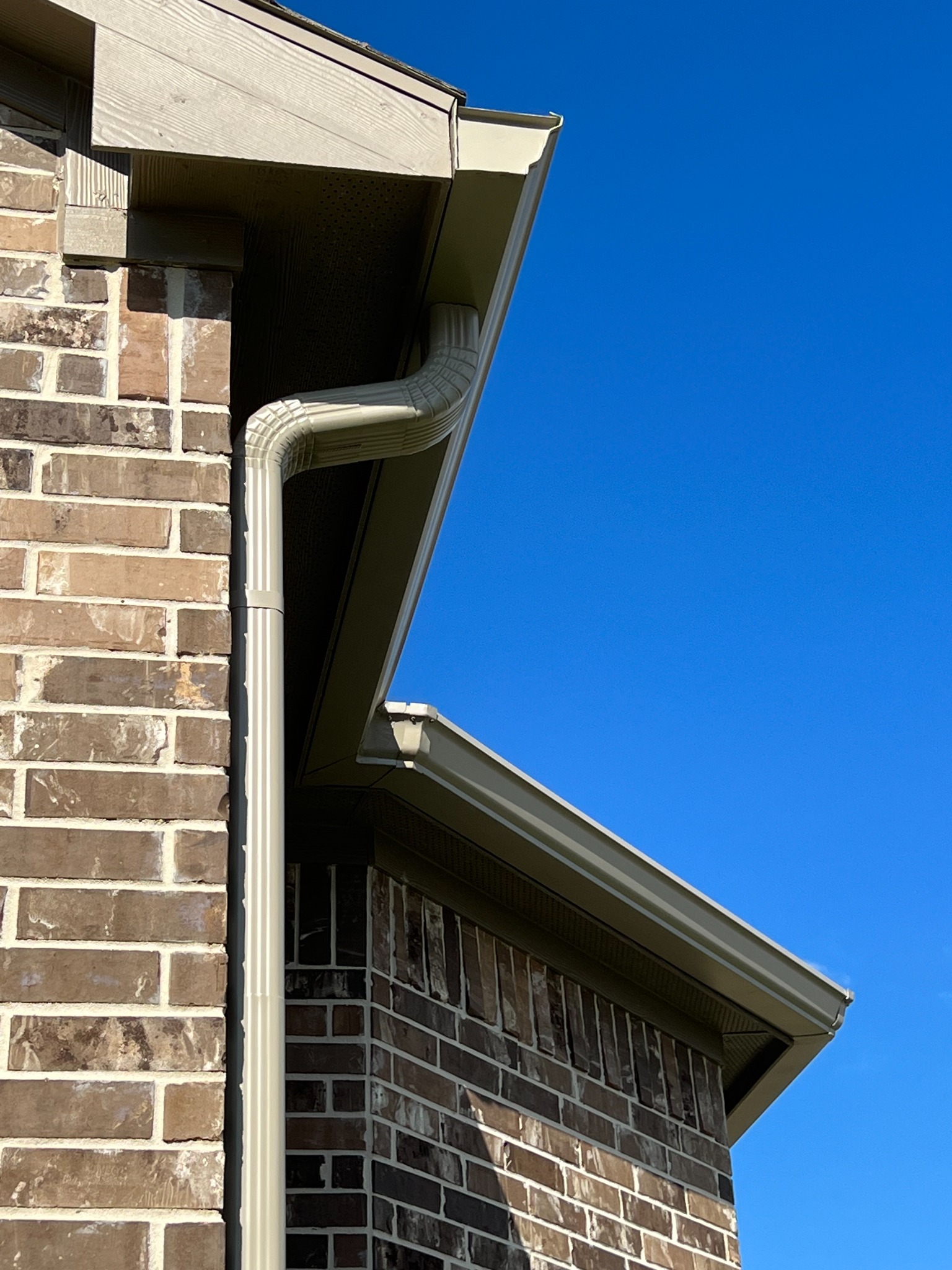 Beige seamless gutter and downspout detail