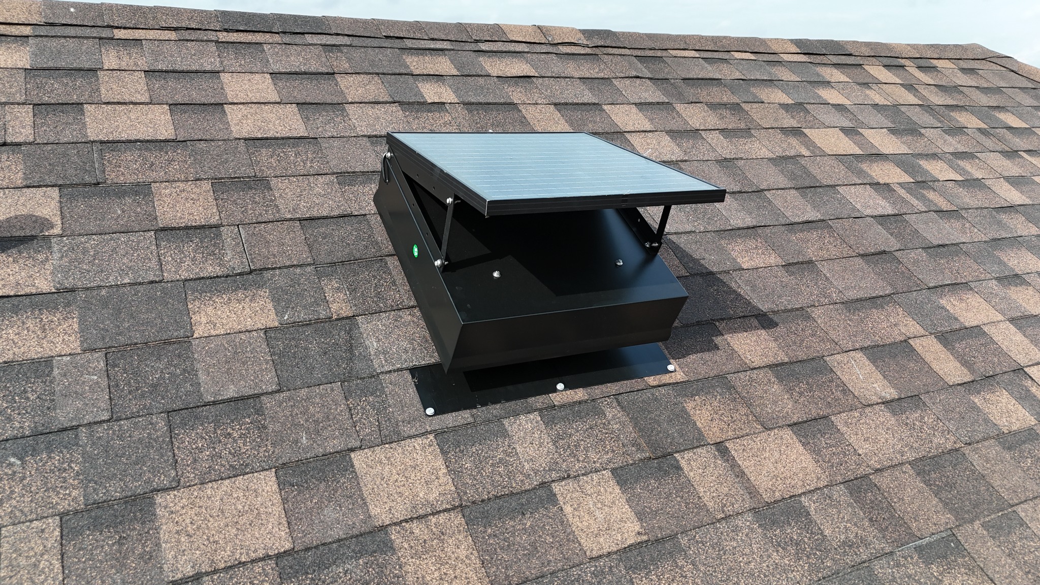 Solar attic fan installed on an architectural shingle roof