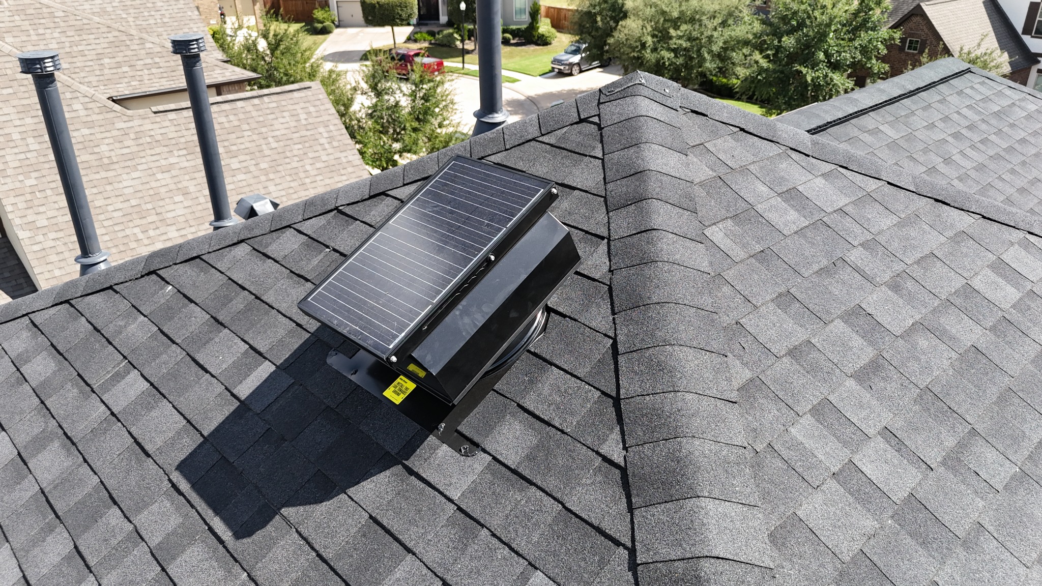 Solar attic fan on a residential roof in Cypress